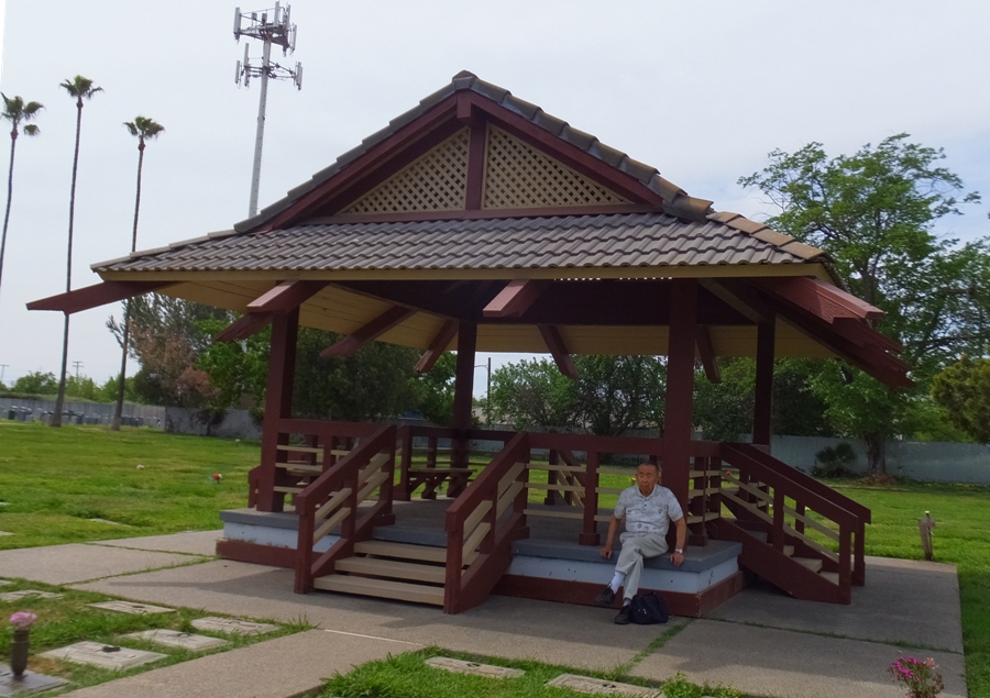 Dad sitting at Asian-looking gazebo