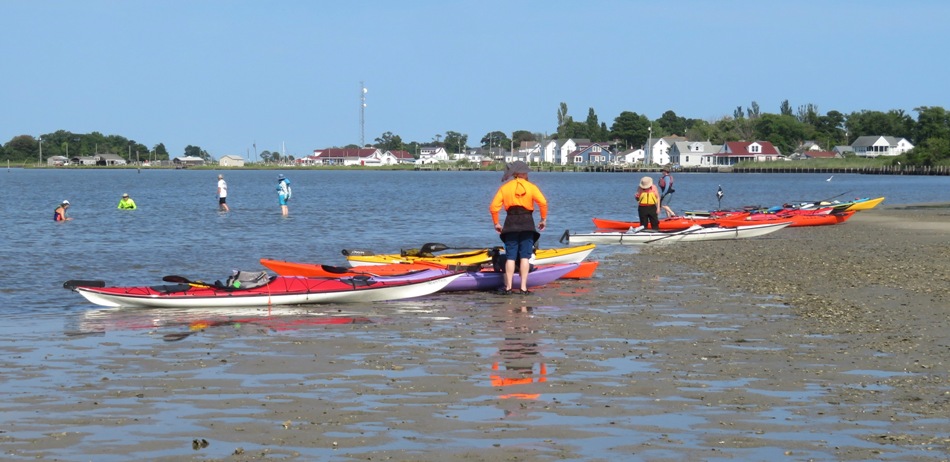 Kayaks pulled ashore with Ewell behind