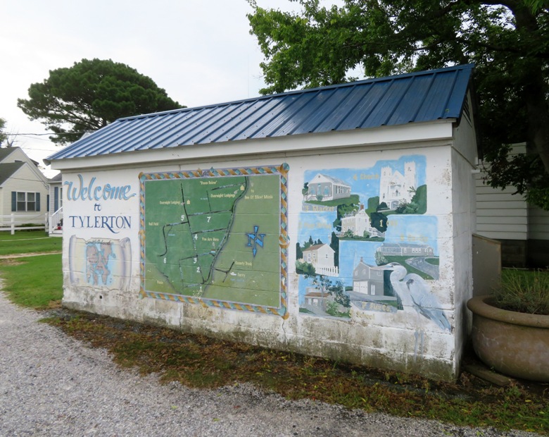 Small building with the town mural painted on it