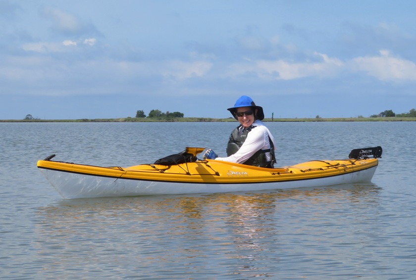 Woman smiling in yellow kayak