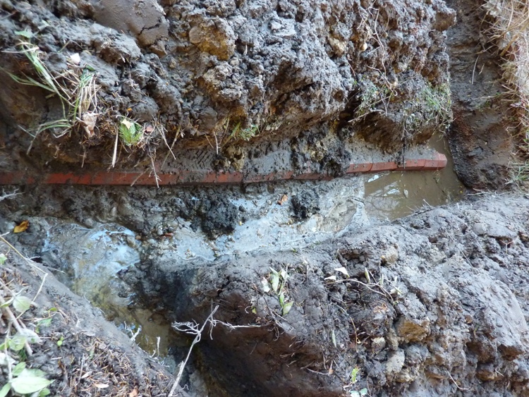 Terracotta tubes along muddy water