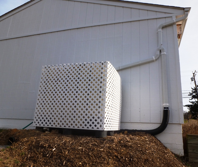 Rain box enclosed in PVC lattice on south side of our property