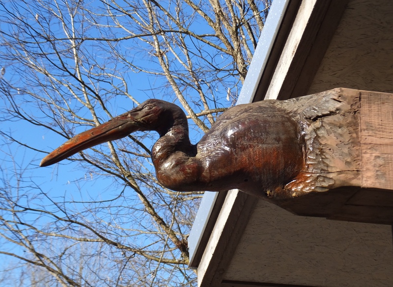 Heron head carved into beam