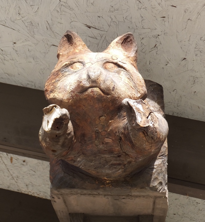 Raccoon head carved into beam