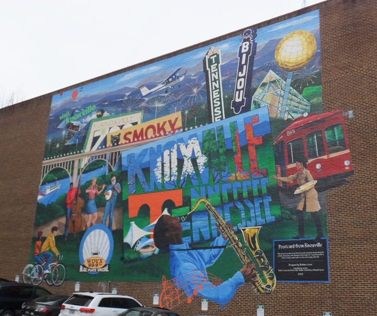 Colorful mural on side of building showing scenes in Knoxville