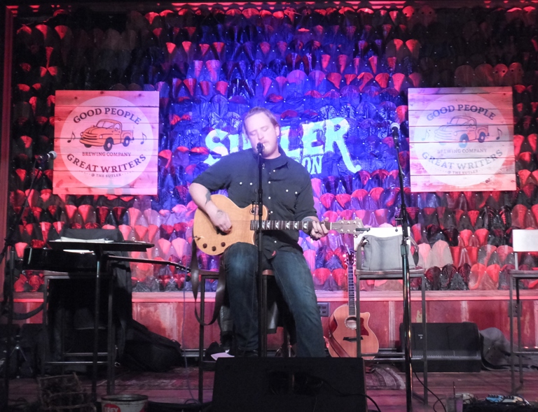 Justin Johnson singing and playing guitar