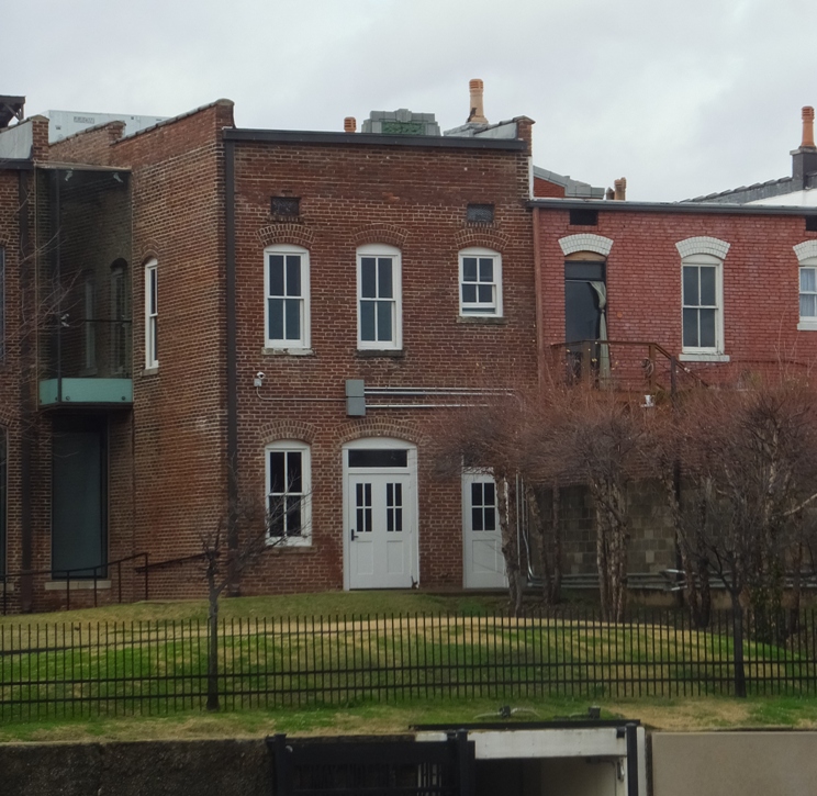 Brick building with window slightly ajar