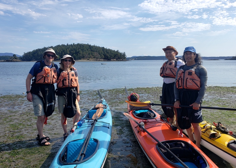 Chris, Dorota, Steve, and me with kayaks on the beach