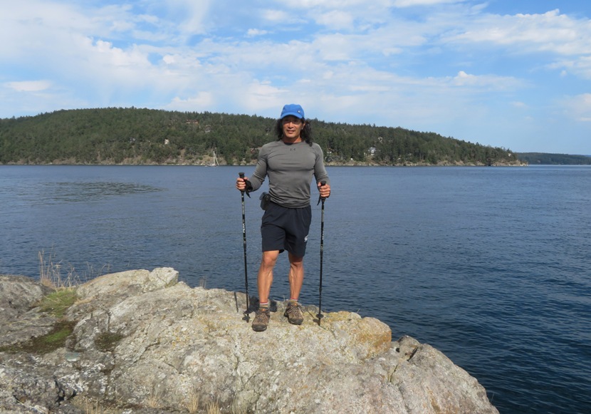 Me standing on a rock with my hiking poles in hand