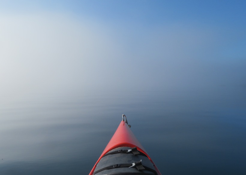 Bow of kayak and fog