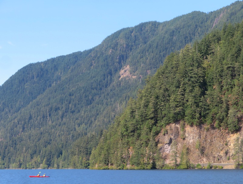 Kayakers on Lake Crescent with mountain behind