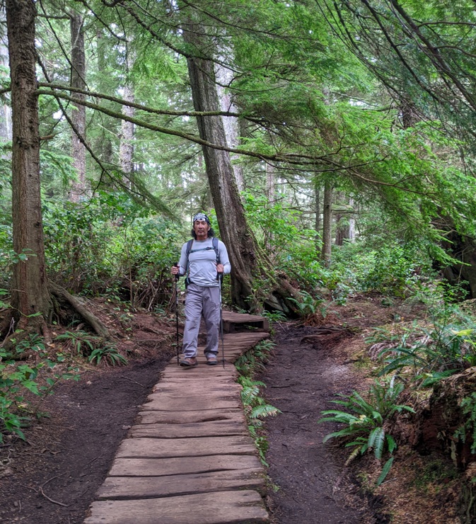 Me walking on boardwalk using hiking poles