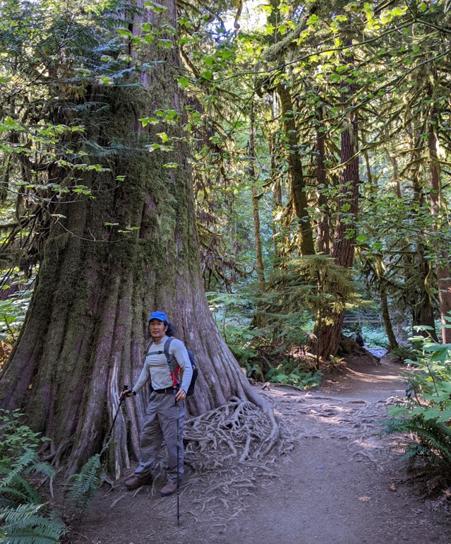 Me in front of tree on trail