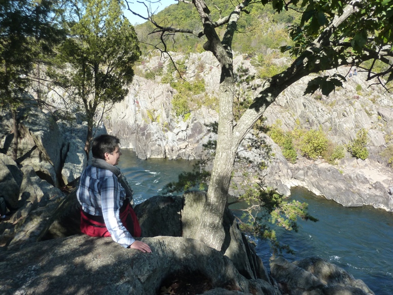 Angelika seated on a rock looking across the Potomac River