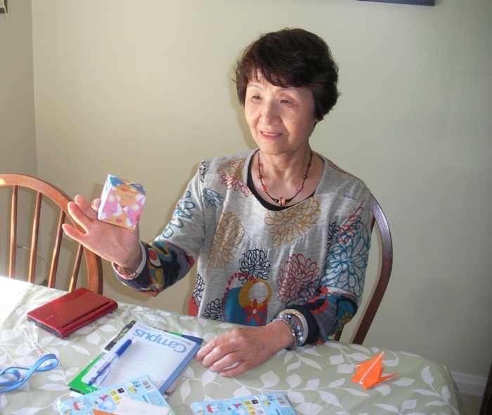 Hitomi holding an origami cube