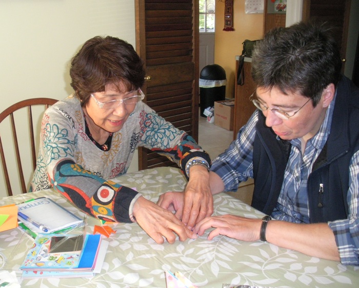 Hitomi teaching Angelika origami