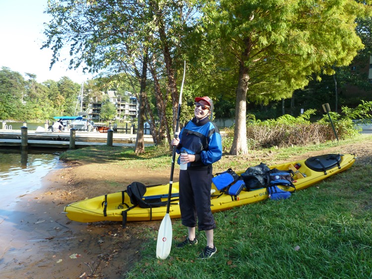 Angelika on land, standing next to tandem kayak