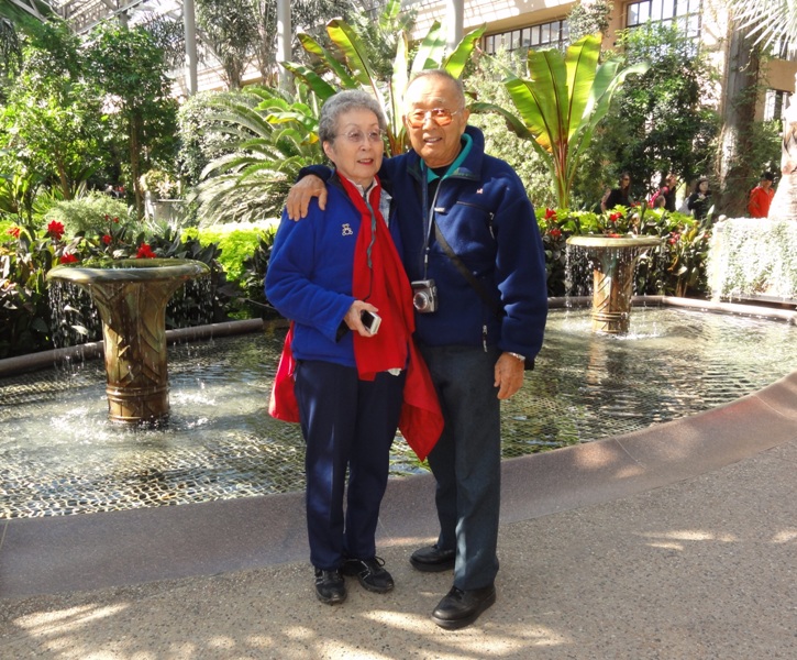 Mom and Dad with indoor fountains behind