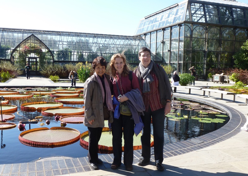 Hitomi, Norma, and Angelika in front of pond with giant leaves