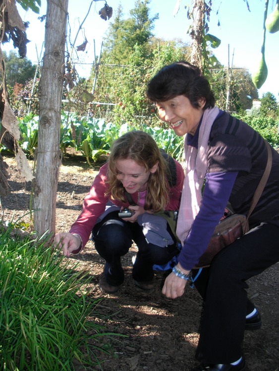 Norma and Hitomi smiling and looking at something down low