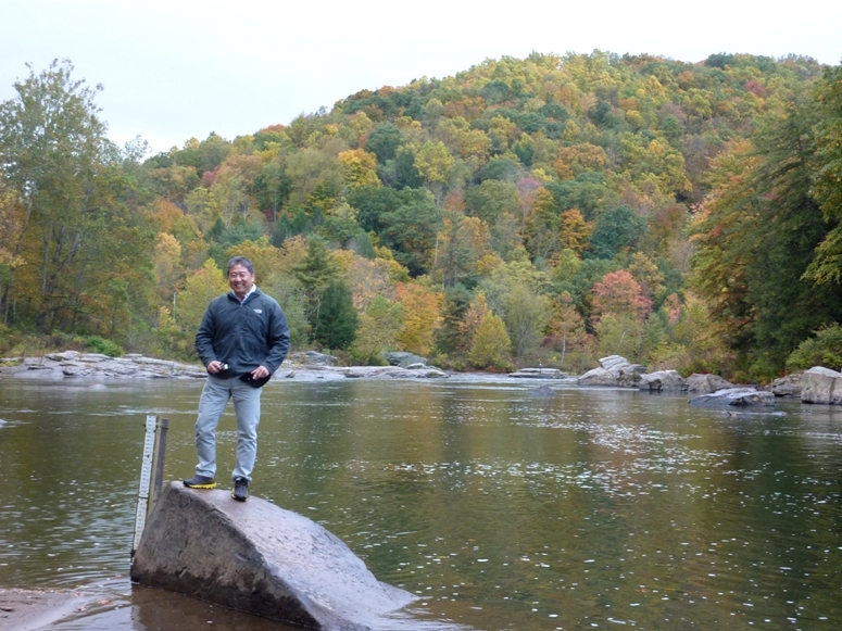 Steve standing with tree-covered hill behind