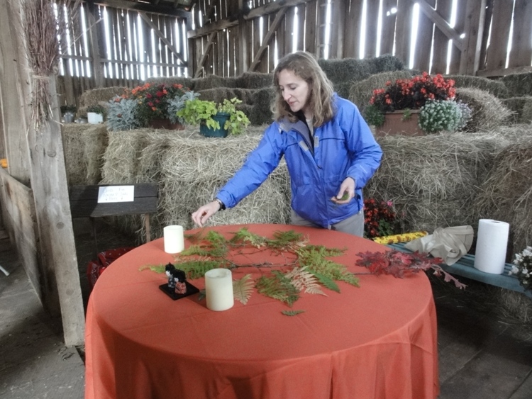 Norma scattering fern leaves on table