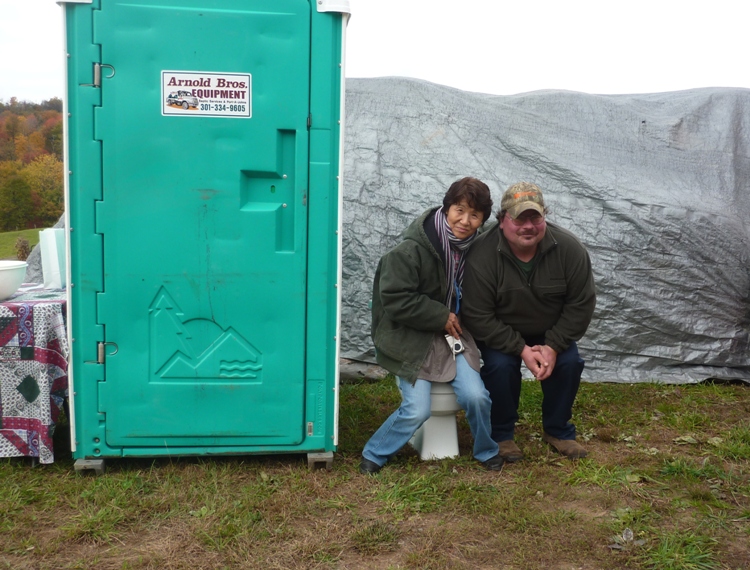 Hitomi and Scott next to porta-john