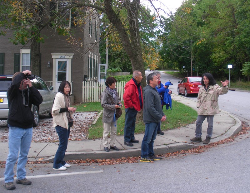 Me leading tour in front of brick duplexes