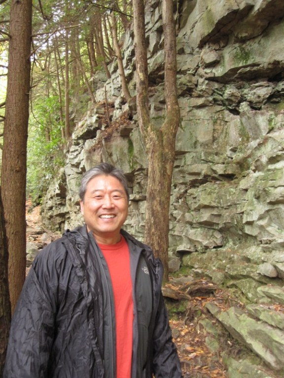 Cousin Steve by craggy vertical rock wall