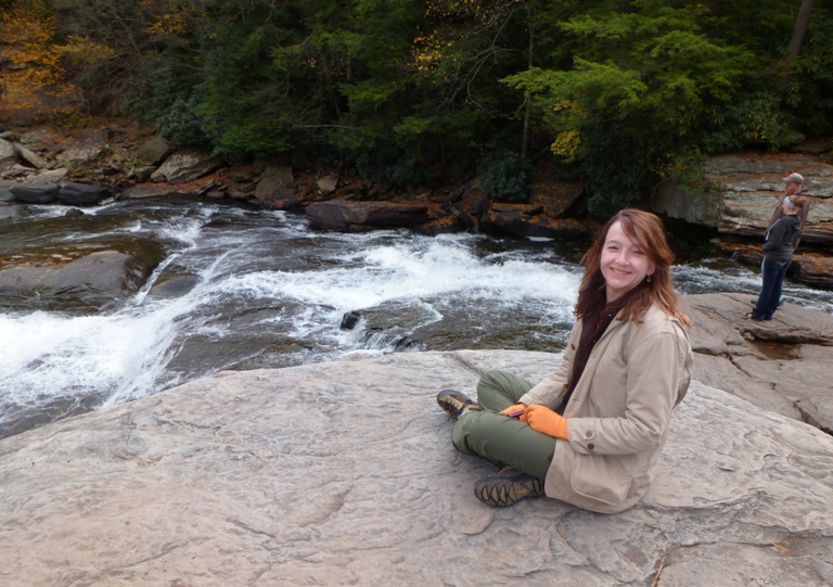 Lisa sitting on a rock at Upper Swallow Falls