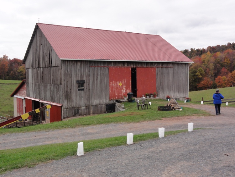 Barn with white bags in front, each containing a light