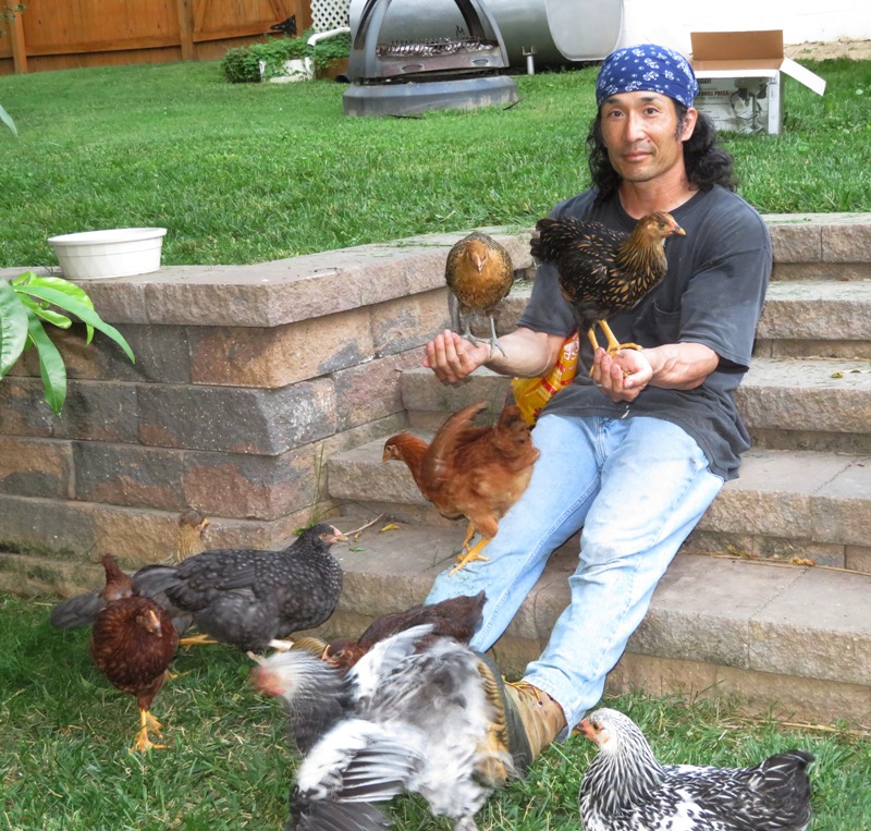 Me sitting with a chicken in each hand