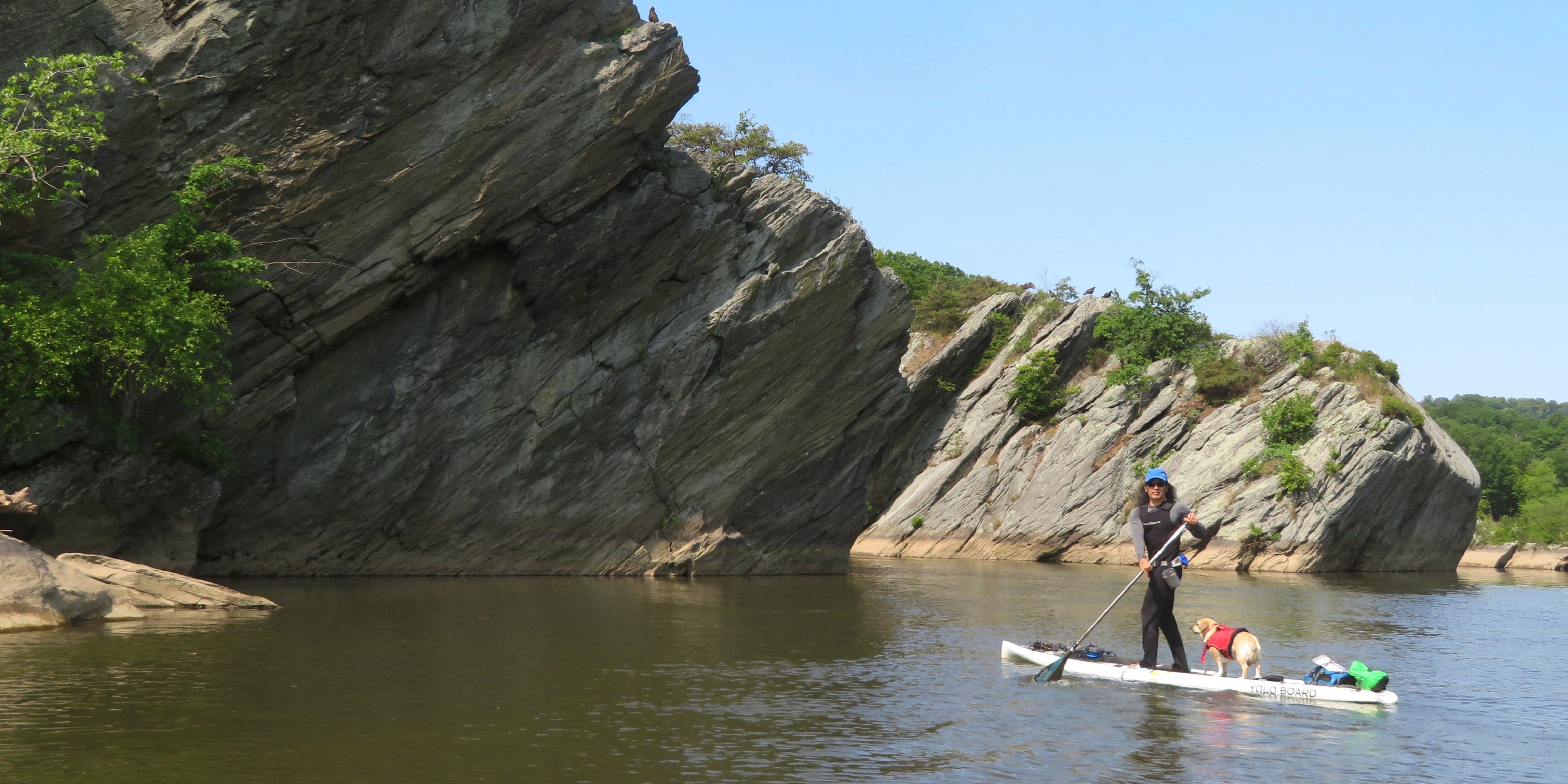 Daphne and I on SUP with giant boulders behind