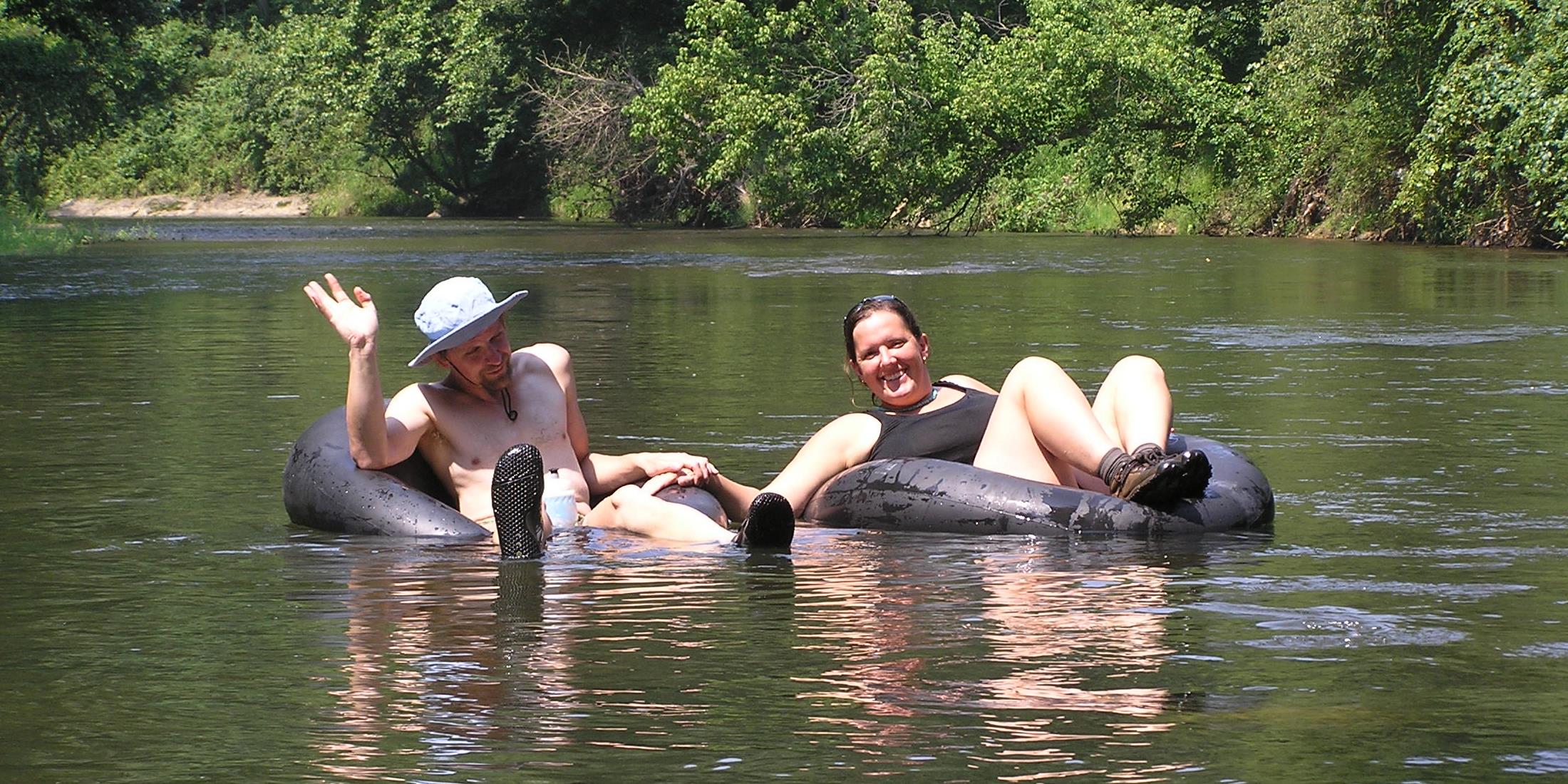 Couple tubing on river