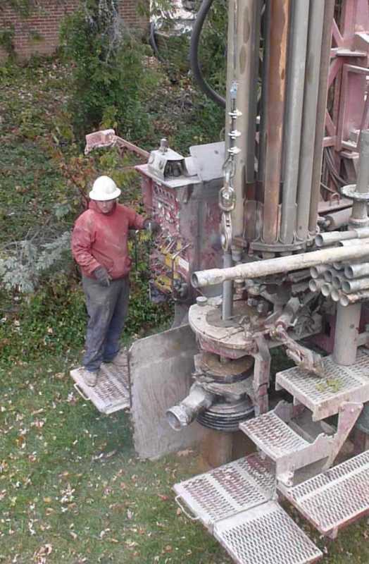 Man operating drilling machine