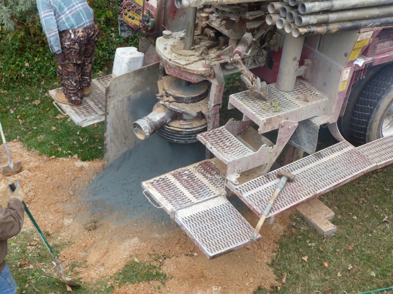 Drilling machine pulling up crushed rock