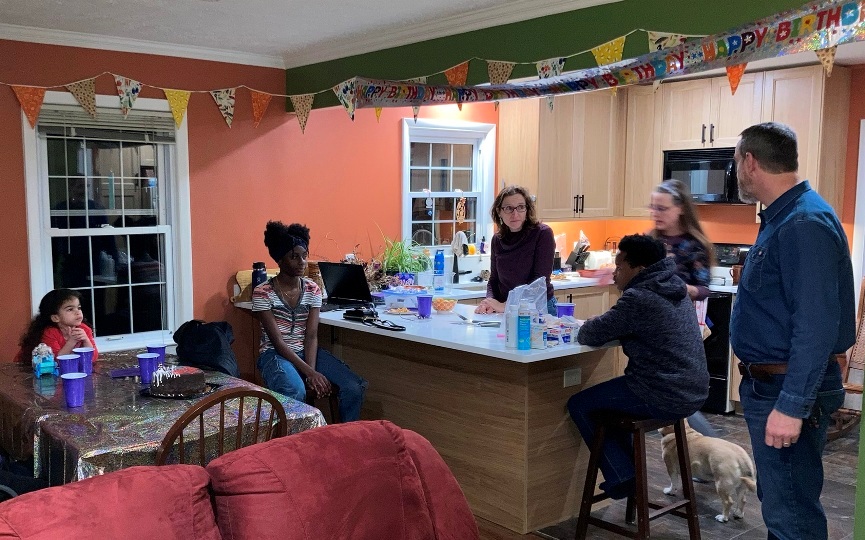 Norma's extended family in the kitchen and part of the living room