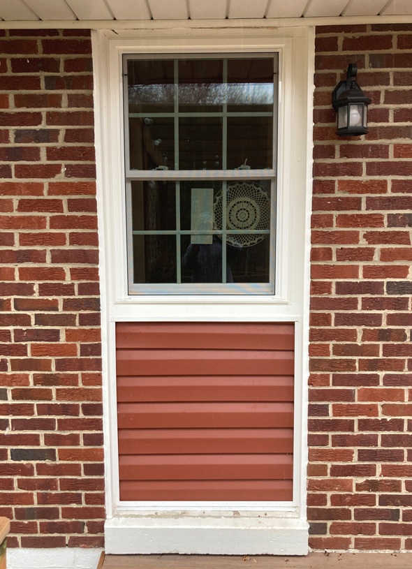 Vinyl siding below kitchen window, viewed from the deck