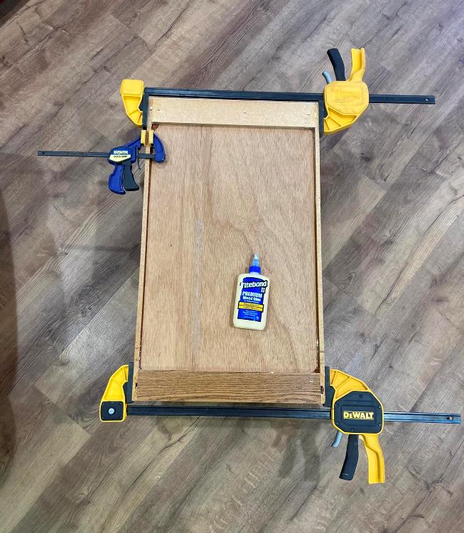 Old kitchen cabinet with clamps, being reglued together