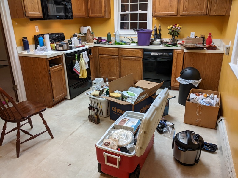 Items in boxes and coolers in the kitchen, waiting to be moved into the garage