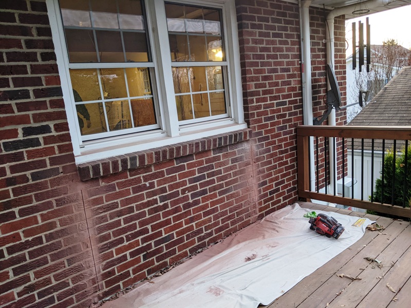 View from deck of brick cut on wall opposite kitchen