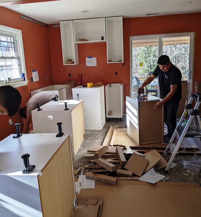 Guys from Kitchen Renovation putting together Ikea kitchen cabinets