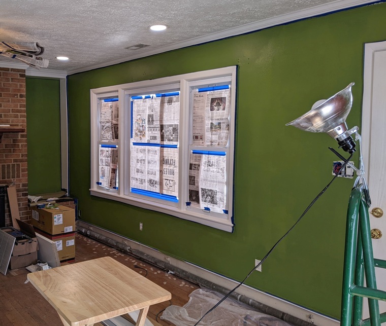 Windows covered with newspaper with Valspar Green Jalapeno on the wall