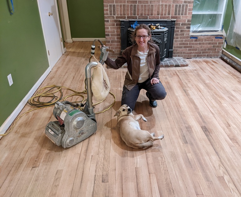 Norma, Daphne, and drum sander on hardwood floor on first day of sanding