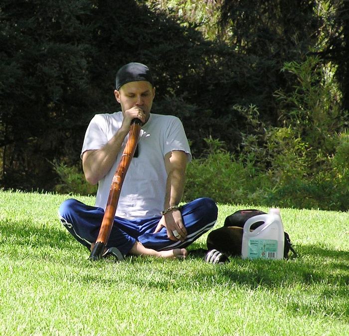 Man blowing into didgeridoo