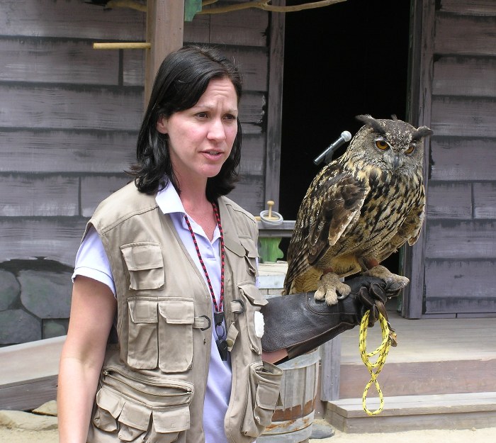 Woman with European great horned owl on her arm