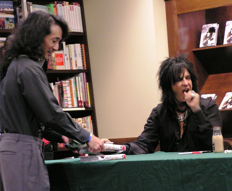 Nikki yawning and handing me my autographed book