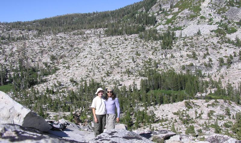 Norma and I on a rocky plateau with other mountains behind