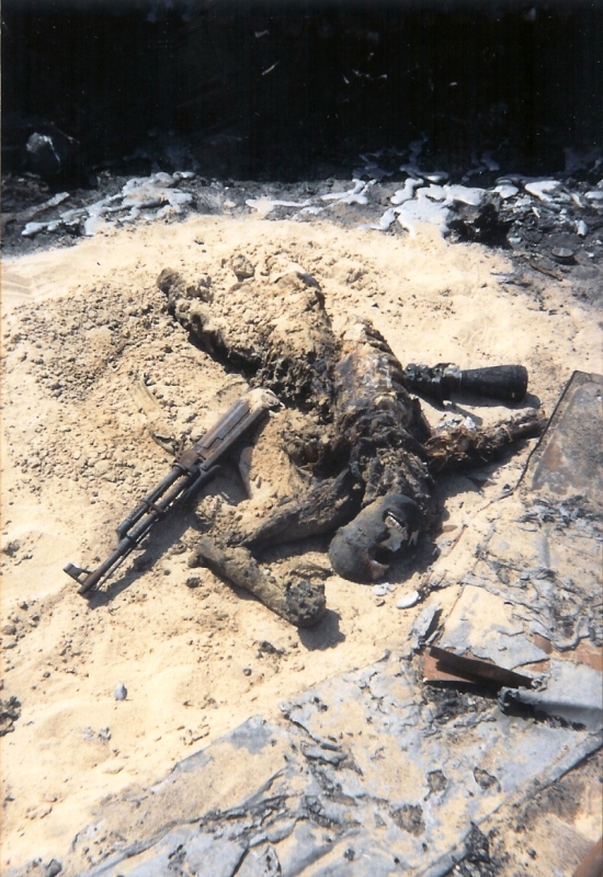 Burnt corpse with broken rifle