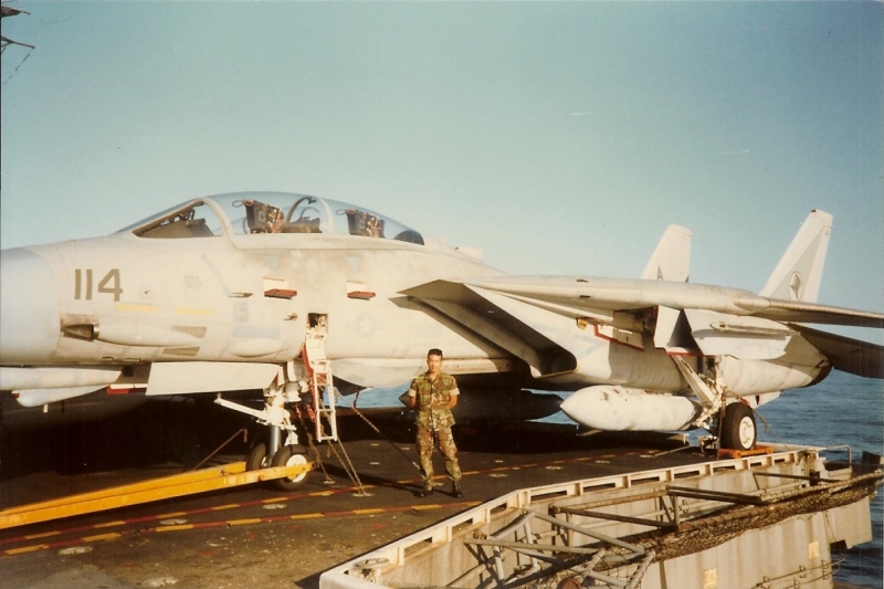 Me by a fighter plane, I think an F-14